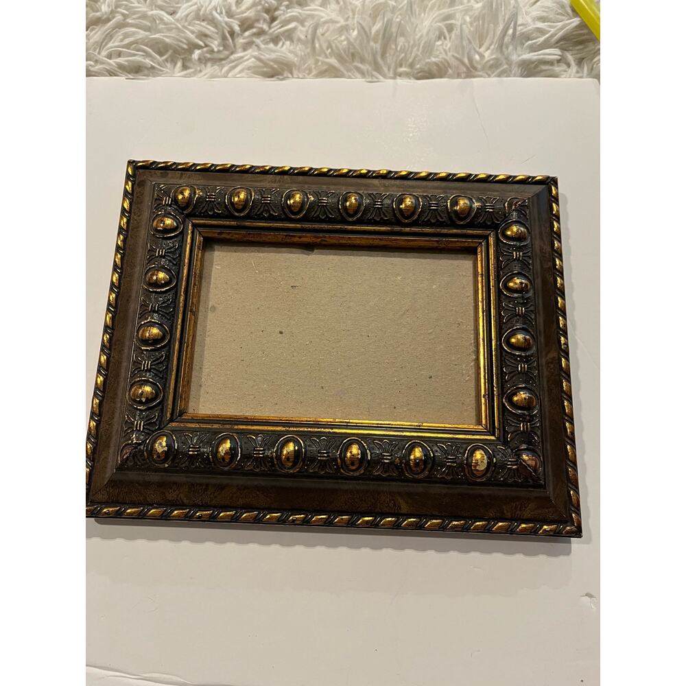 8x10 ornate frame holds 4X6 photo gold brushed design  on hard plastic not wood